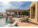 Outdoor patio with pool, waterfall feature, and covered lounge area for entertaining at 27632 N 68Th Pl, Scottsdale, AZ 85266