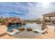 Gorgeous pool area with a rock waterfall, slide, and lounge chairs in the water at 27632 N 68Th Pl, Scottsdale, AZ 85266