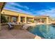 Stunning pool area with a covered patio, rock waterfall, and outdoor seating at 27632 N 68Th Pl, Scottsdale, AZ 85266