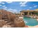 Backyard pool and outdoor living space with a rock waterfall and slide at 27632 N 68Th Pl, Scottsdale, AZ 85266