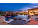 Backyard pool features a rock waterfall, slide, swim up bar stools, and lounge chairs at 27632 N 68Th Pl, Scottsdale, AZ 85266