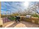 Outdoor kitchen and grill area adjacent to a sports court, perfect for entertaining at 27632 N 68Th Pl, Scottsdale, AZ 85266