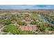 Panoramic aerial view showcasing tennis courts, lakes, and golf course with stunning mountain backdrop at 27792 N 129Th Ln, Peoria, AZ 85383