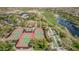 Overhead view of tennis courts, lawn bowling, and a picturesque lake surrounded by lush greenery at 27792 N 129Th Ln, Peoria, AZ 85383