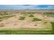 Overhead view of a beautifully landscaped golf course surrounded by desert terrain and mountains at 27792 N 129Th Ln, Peoria, AZ 85383