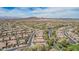 Expansive aerial view of a desert community featuring tile roofs, tree-lined streets and mountain views at 27792 N 129Th Ln, Peoria, AZ 85383