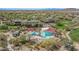 Stunning aerial view of the community pool area with lounge chairs and shady umbrellas at 27792 N 129Th Ln, Peoria, AZ 85383