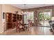 Elegant dining area with modern chandelier, custom cabinetry, and a seamless connection to the outdoors at 27792 N 129Th Ln, Peoria, AZ 85383