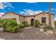 Inviting home exterior with well-maintained desert landscaping and a stone pathway leading to the front door at 27792 N 129Th Ln, Peoria, AZ 85383