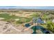 Overhead view of lush golf course with water features and a bridge, set against a desert landscape at 27792 N 129Th Ln, Peoria, AZ 85383