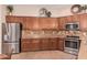 Spacious kitchen features stainless steel appliances, stone countertops, and wood cabinets at 27792 N 129Th Ln, Peoria, AZ 85383