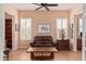 Cozy living room with neutral walls, plantation shutters, and a leather sofa at 27792 N 129Th Ln, Peoria, AZ 85383