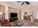 Comfortable living room featuring tile floors and a ceiling fan, perfect for relaxation at 27792 N 129Th Ln, Peoria, AZ 85383