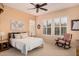 Cozy main bedroom featuring a ceiling fan, plantation shutters and neutral colors at 27792 N 129Th Ln, Peoria, AZ 85383