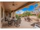 Covered patio area perfect for outdoor dining and lounging, overlooking the backyard at 27792 N 129Th Ln, Peoria, AZ 85383