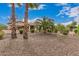 Charming home exterior showcasing desert landscaping with palm trees and comfortable outdoor living at 27792 N 129Th Ln, Peoria, AZ 85383