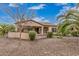 Charming home exterior with a desert landscape, patio, and seating area for outdoor relaxation at 27792 N 129Th Ln, Peoria, AZ 85383