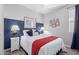 Well-lit bedroom featuring a plush bed, accent wall, and a window at 2807 W Canada De Oro Rd, Queen Creek, AZ 85144