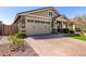 Beautiful home showcasing a brick driveway, well-maintained lawn, and charming exterior at 2807 W Canada De Oro Rd, Queen Creek, AZ 85144