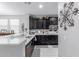 Stylish kitchen featuring quartz countertops, stainless steel sink, and dark cabinetry at 2807 W Canada De Oro Rd, Queen Creek, AZ 85144