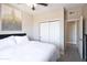 Bright bedroom with white bedding, closet, ceiling fan and modern neutral-toned decor at 2992 N Miller Rd # A202, Scottsdale, AZ 85251