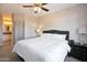 Bright bedroom featuring neutral paint, ceiling fan, carpet, and large bed and dresser at 2992 N Miller Rd # A202, Scottsdale, AZ 85251