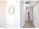 Hallway with wood floors, white trim, doors and a decorative mirror at 2992 N Miller Rd # A202, Scottsdale, AZ 85251