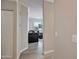 Hallway leading to a cozy living room with neutral walls and hardwood flooring, creating a seamless transition at 2992 N Miller Rd # A202, Scottsdale, AZ 85251