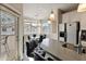 Modern kitchen featuring a breakfast bar, stainless steel appliances, and an adjacent dining area with natural light at 2992 N Miller Rd # A202, Scottsdale, AZ 85251