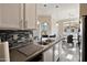 Modern kitchen featuring stainless sink, stainless appliances, grey countertops, and views of the dining area at 2992 N Miller Rd # A202, Scottsdale, AZ 85251