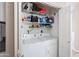 Inside a laundry room with a washer and dryer, shelving and cleaning products at 2992 N Miller Rd # A202, Scottsdale, AZ 85251