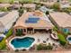 Aerial view of a backyard oasis with a sparkling pool, fire pit, and outdoor entertaining space at 30110 N 129Th Gln, Peoria, AZ 85383