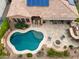 Aerial view of a backyard oasis with a sparkling pool, fire pit, and lounge chairs at 30110 N 129Th Gln, Peoria, AZ 85383