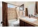 Bathroom with single vanity, shower-tub combo, and tiled walls at 30110 N 129Th Gln, Peoria, AZ 85383