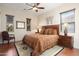 Cozy bedroom featuring a ceiling fan, two windows, area rug, and stylish furniture at 30110 N 129Th Gln, Peoria, AZ 85383