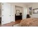 Bedroom with tile flooring, closet with sliding doors, and decorative dresser under artwork at 30110 N 129Th Gln, Peoria, AZ 85383