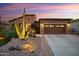 Well-maintained home exterior featuring desert landscaping and a two-car garage for convenience and style at 30110 N 129Th Gln, Peoria, AZ 85383