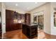 Kitchen island and cabinetry with stainless steel appliances, and terracotta floors at 30110 N 129Th Gln, Peoria, AZ 85383