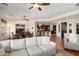 Open-concept living room featuring a cozy white sofa and seamless flow into the kitchen and dining areas at 30110 N 129Th Gln, Peoria, AZ 85383