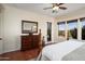 Bright main bedroom with terracotta floors, a large window, and door leading to patio at 30110 N 129Th Gln, Peoria, AZ 85383