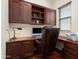 Comfortable home office with a large wooden desk and a leather office chair at 30110 N 129Th Gln, Peoria, AZ 85383