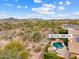 Inviting pool and patio area with a cozy fire pit, perfect for outdoor living and relaxation at 30110 N 129Th Gln, Peoria, AZ 85383