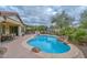 Inviting backyard featuring a sparkling pool, patio area, and lush landscaping at 30550 N 125Th Dr, Peoria, AZ 85383