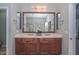 Bathroom featuring double sinks, a large mirror, and a modern vanity at 30550 N 125Th Dr, Peoria, AZ 85383