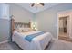 Bedroom featuring a ceiling fan, plantation shutters and view into the hallway at 30550 N 125Th Dr, Peoria, AZ 85383