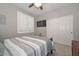 Cozy bedroom with ceiling fan, shuttered window and carpeted floors at 30550 N 125Th Dr, Peoria, AZ 85383