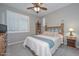 Bedroom featuring a ceiling fan, plantation shutters and two side tables at 30550 N 125Th Dr, Peoria, AZ 85383