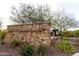 The stone-built entrance to the Foothills Center with trees and shrubbery around the area at 30550 N 125Th Dr, Peoria, AZ 85383