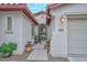 Inviting front entrance with stone pavers, potted plants, security gate, and a covered entry way at 30550 N 125Th Dr, Peoria, AZ 85383