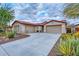 Attractive single-story home featuring a two-car garage and desert landscaping adding to curb appeal at 30550 N 125Th Dr, Peoria, AZ 85383